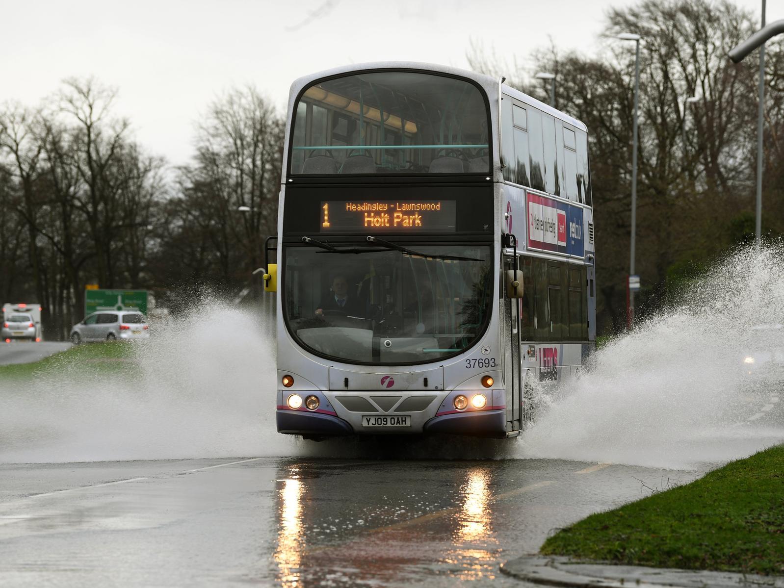 A bus makes its way through flood water on Otley Road.