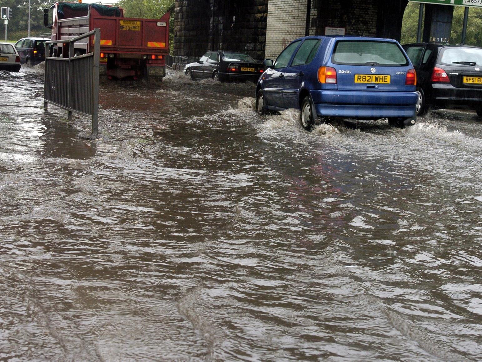Cars drive through flooding under the railway bridge at Armley gyratory in the summer of 2004.