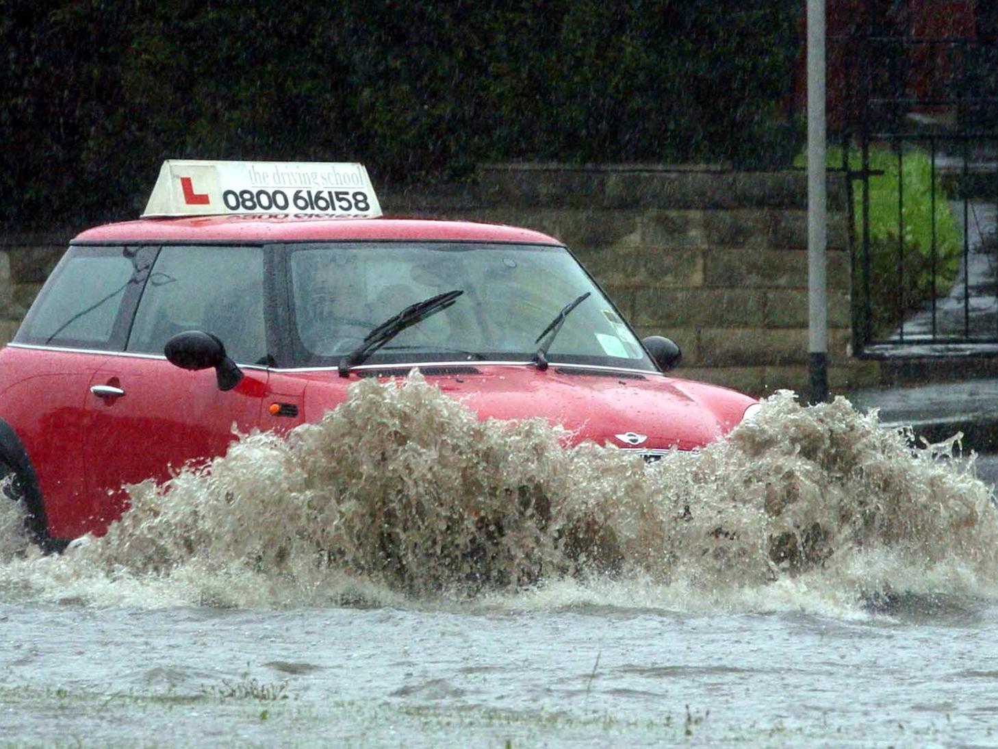 A learner driver battles through flooding  on the A58 Leeds to Wetherby road.