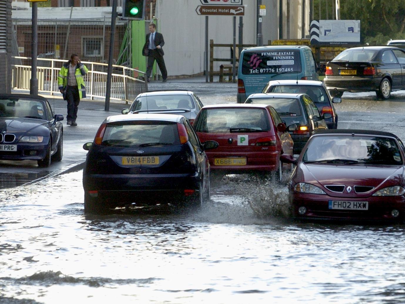 Motorists make their way through flood water on Northern Street in the city centre.
