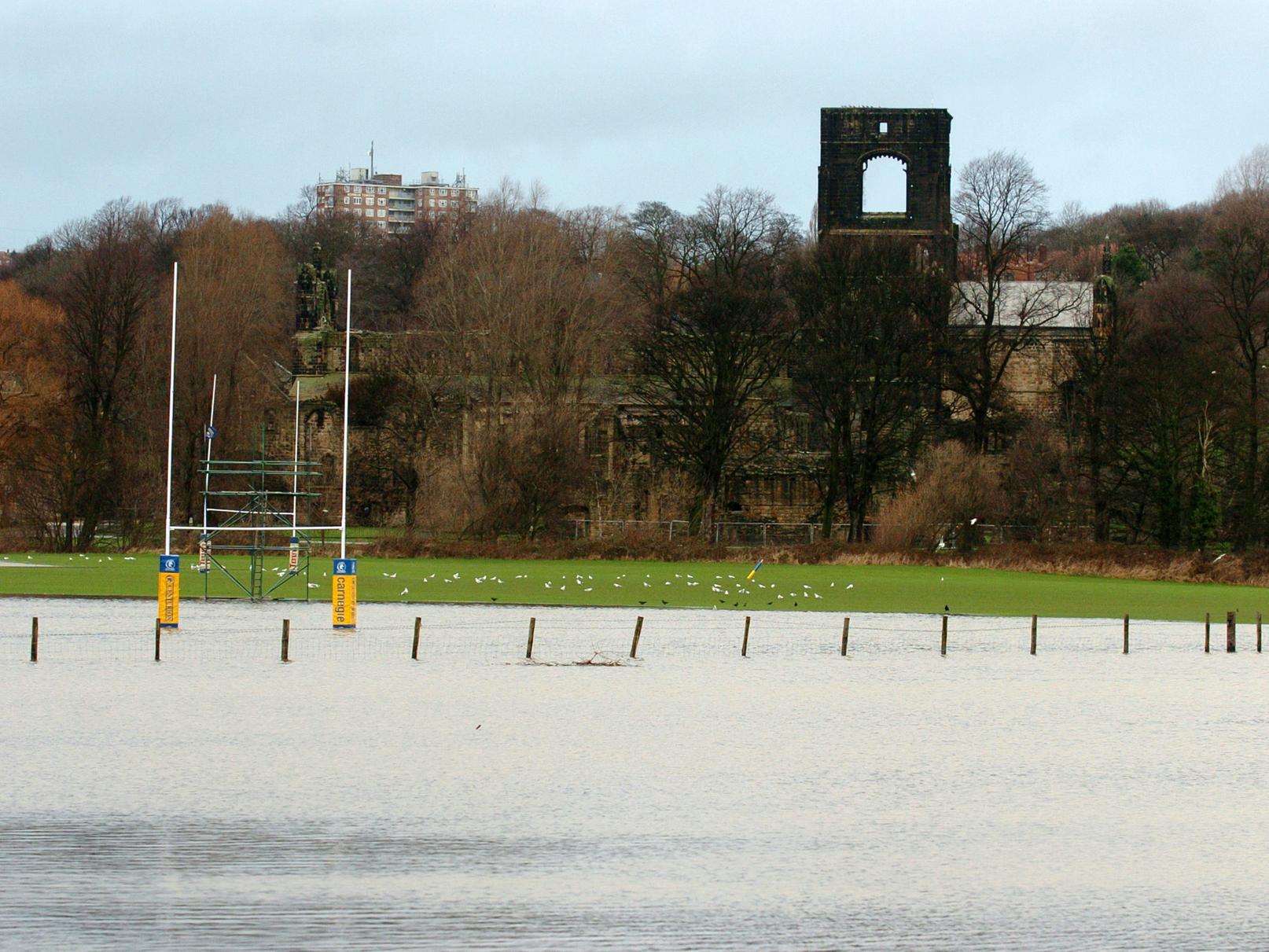 Rugby pitches flooded in the shadow of Kirkstall Abbey.