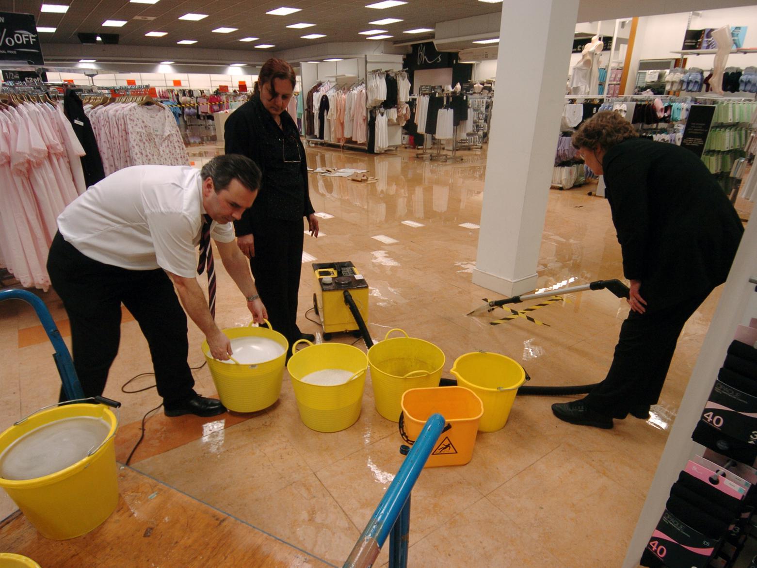 Staff at BHS in Kirkstall mop up the flooded shop floor after the River Aire burst its banks.