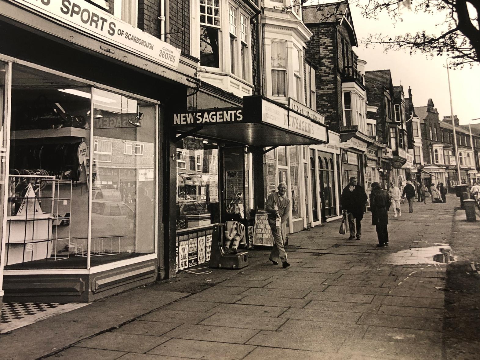In this photo from 1989 a gentleman can be seen picking his paper up from the newsagents. Today he would be collecting a pizza as the building is now a takeaway. The pet shop next door, however, is still there.