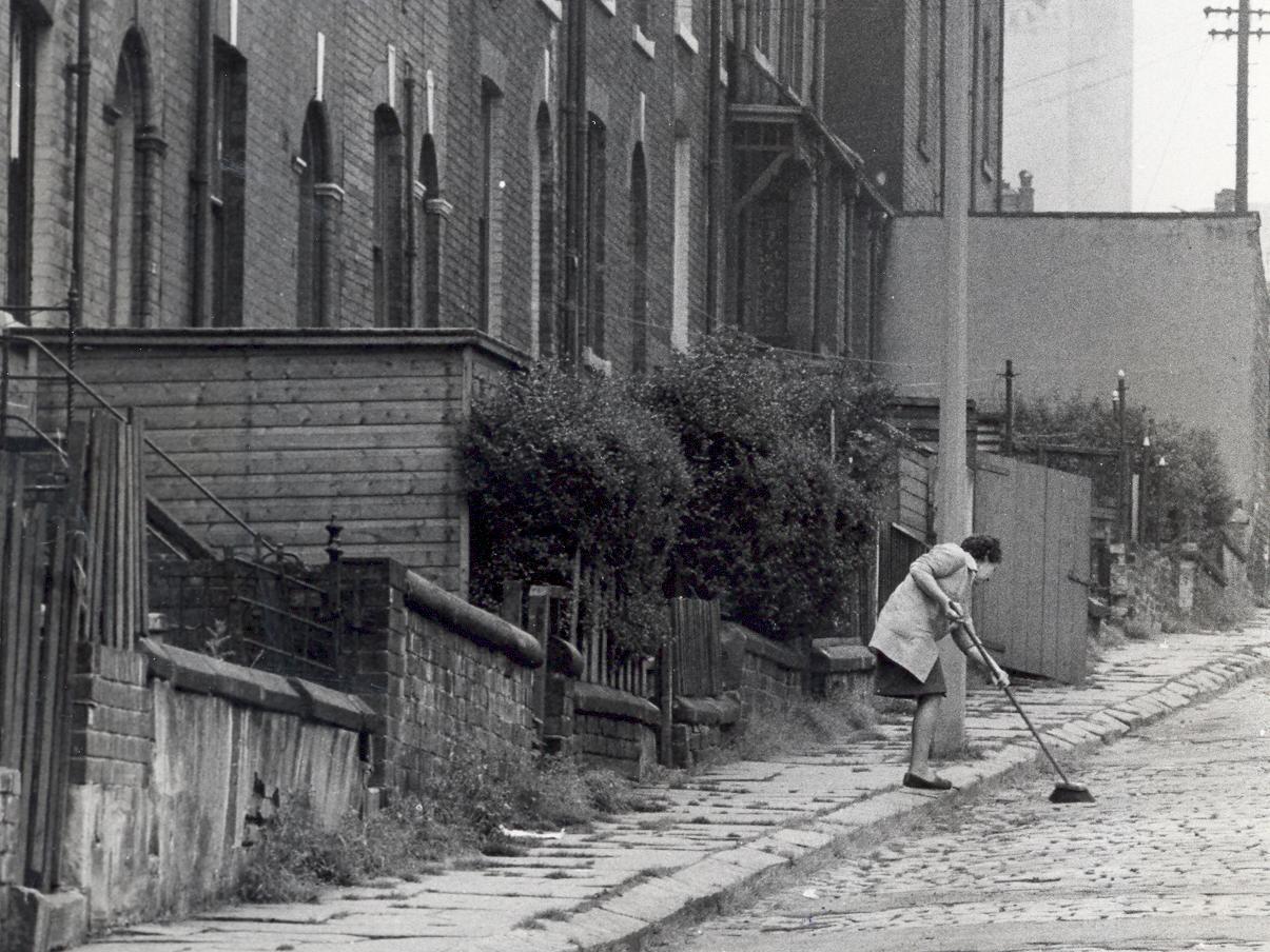A Woodhouse resident sweeps her street. Do you recognise which one?