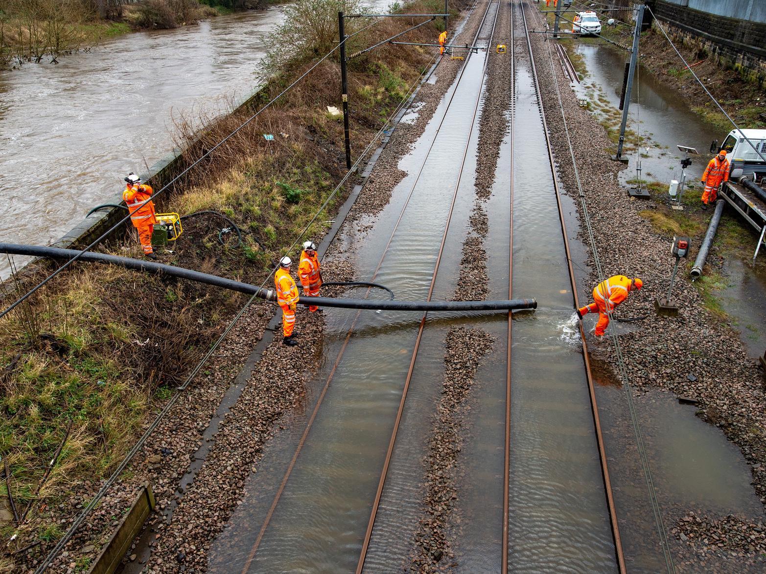 Network Rail engineers work to clear the floodwater from the tracks at Kirkstall Forge station.