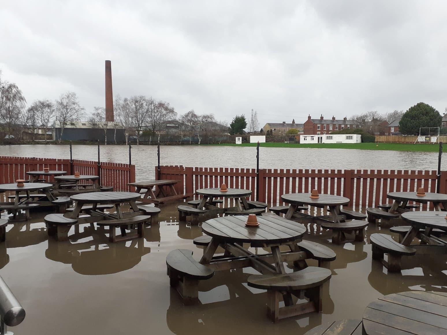 In Horbury Bridge, the river did its worst. At the Horse and Jockey, only fence and furnishings distinguished this pub garden from the nearby river.