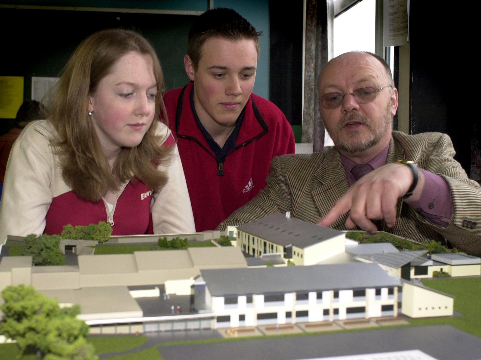 January 2003 and fire-hit Crawshaw School was set to rise from the ashes. Deputy head Patrick Lee shows sixth form students Laura Wetherill and James Adams a model of the new building to be constructed.