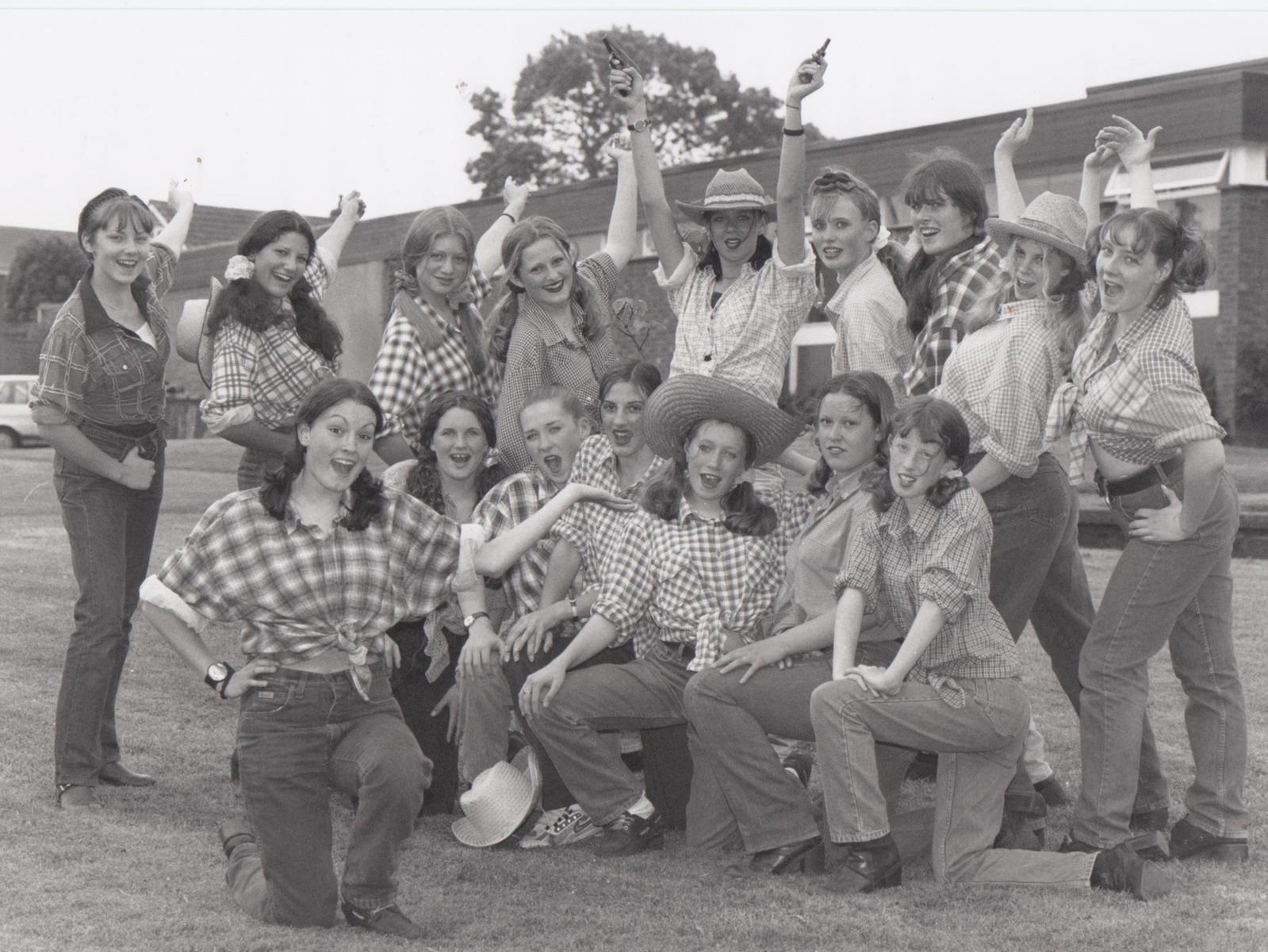An annual tradition at St Augustine's School is an end of term theme day when everyone dresses up - the theme  in 1997 was the movies. Vickie Wyatt, front, as Calamity Jane, who leads the line up singing their version of The Deadwood Stage, called The Old Brid' Bus!