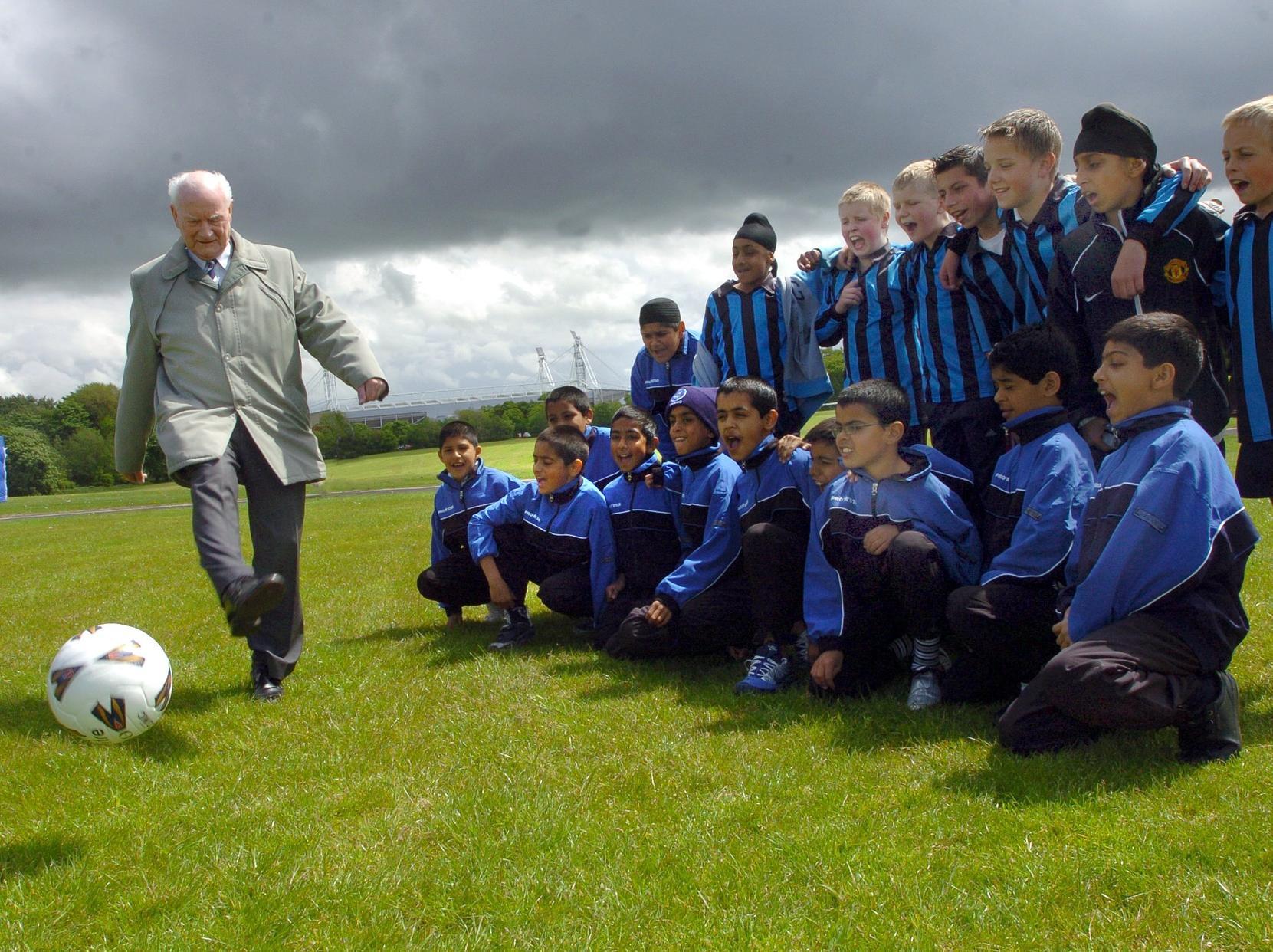 Sir Tom Finney shows off his skills to local schoolchildren on Moor Park
