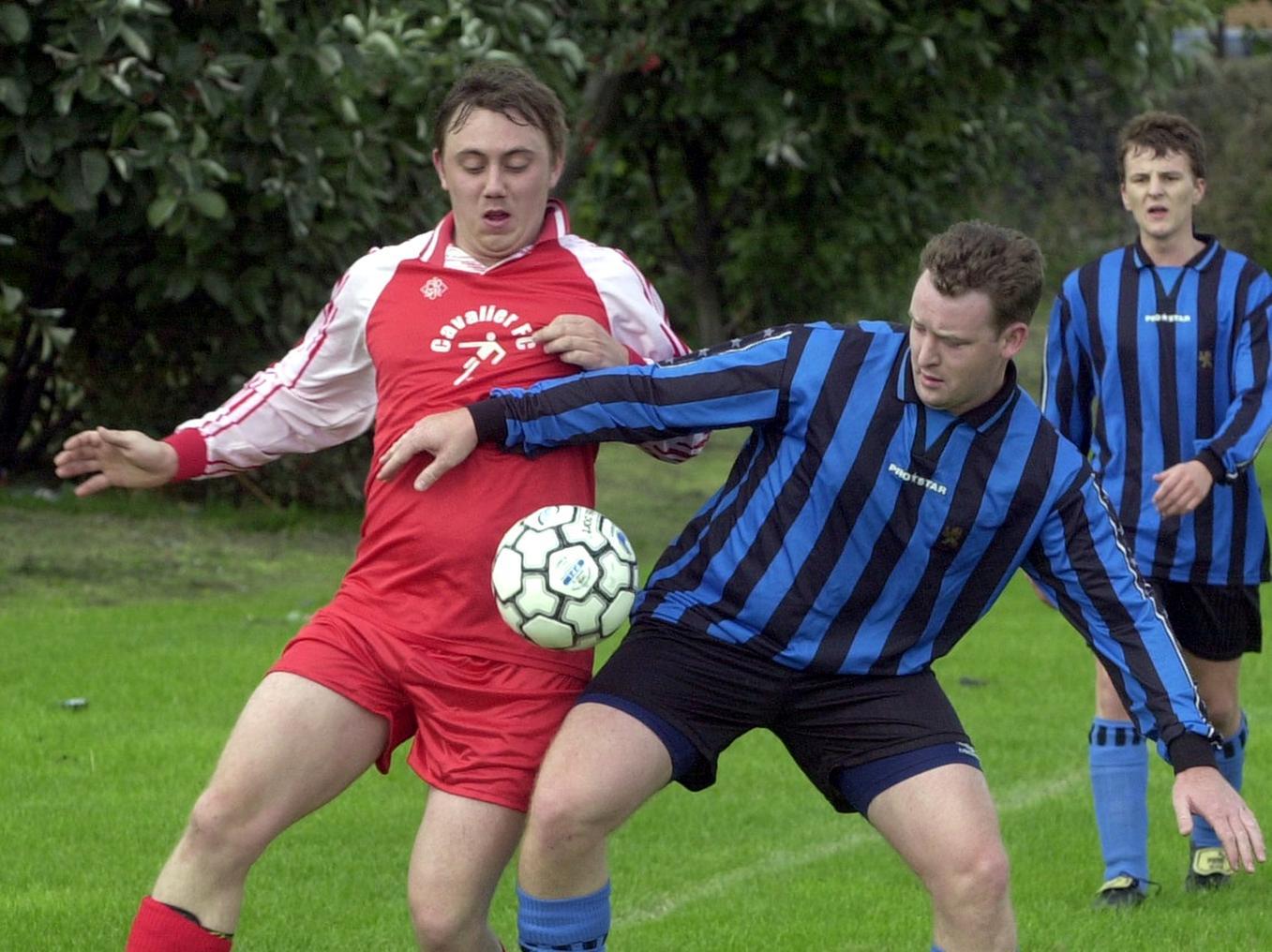 Darren Tosney (left) of Central Ex-Servicemen tussles with Adam Cator of OId Griffin Head in the Leeds Red Triangle League Cup.