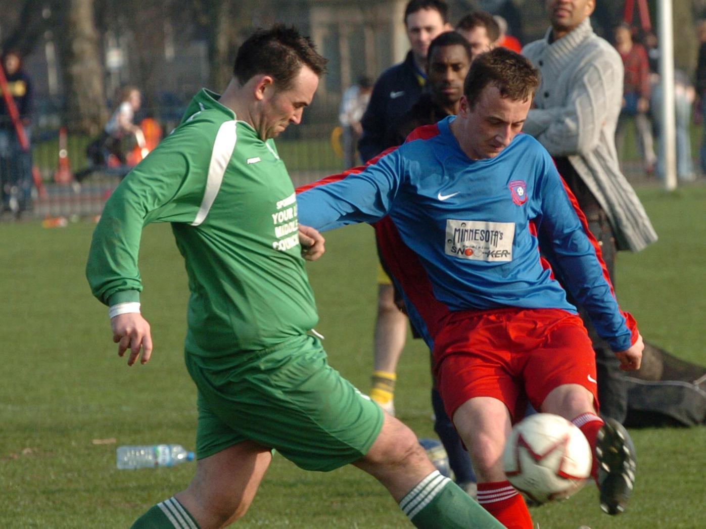 Mark Pearson of Sporting Armley crosses the ball as he is challenged by Simon Johnson of Middleton Park.