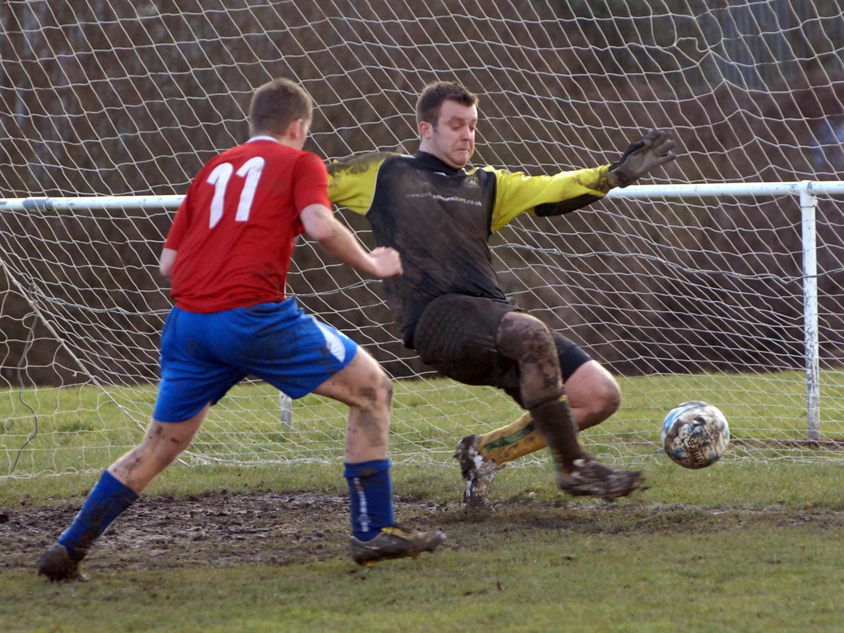 Chris Linfoor in the Hunslet Res goal saves from Mark Jackson of Churwell FC.