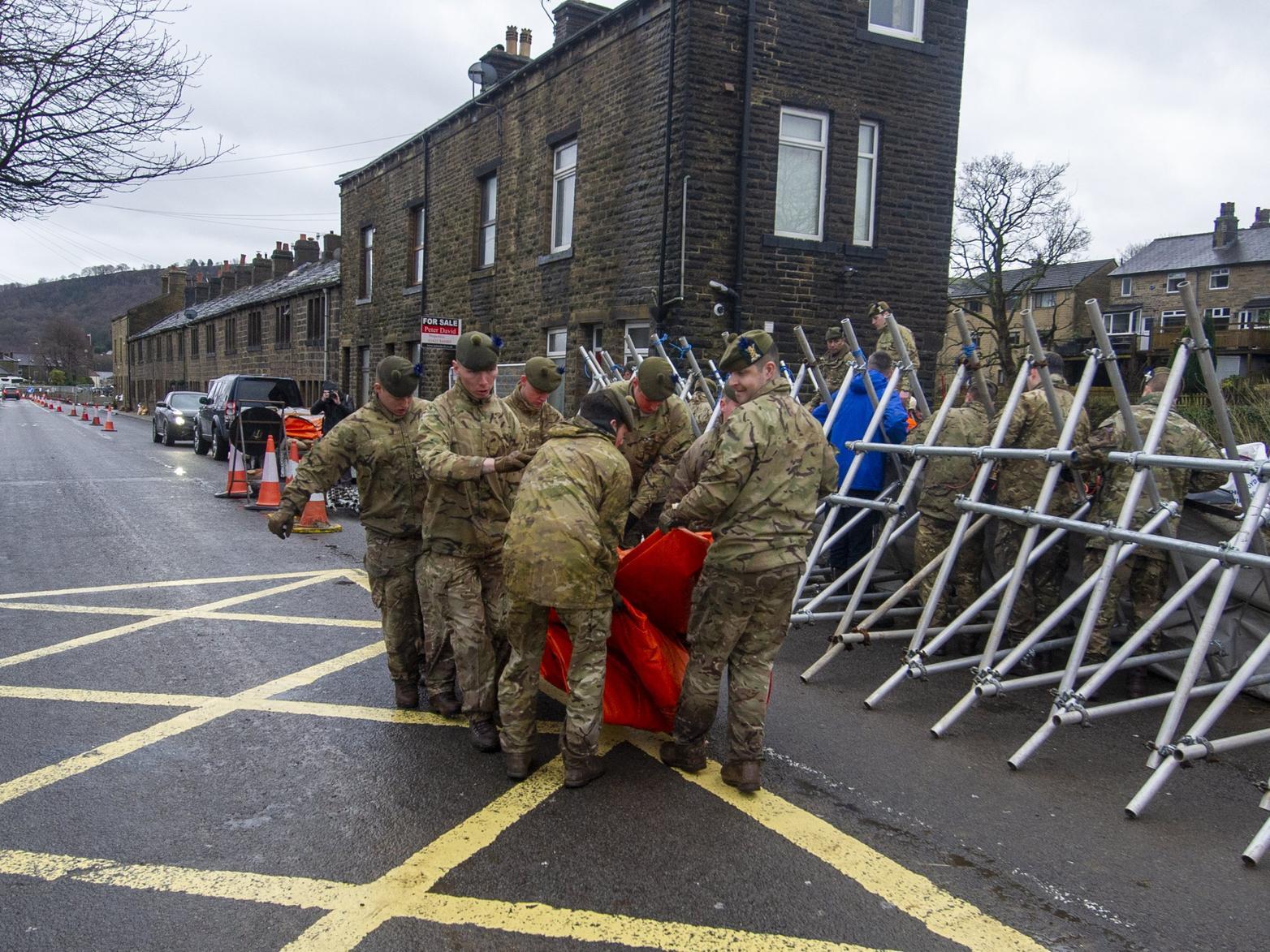 Soldiers from the Highlanders based at Catterick Garrison help build flood defences in Mytholmroyd inn the Calder Valley in preparation for Storm Dennis.