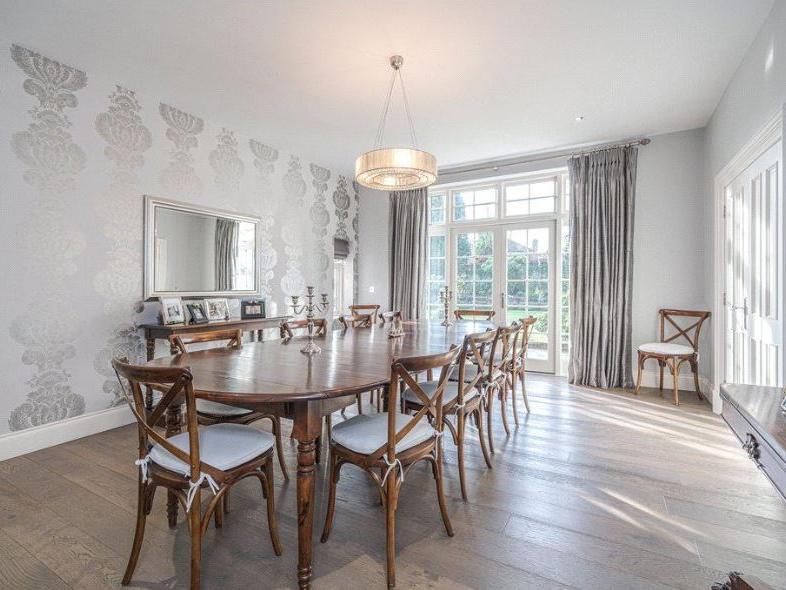 The elegant dining room is bright and airy, and is perfect for both family meals and entertaining guests.