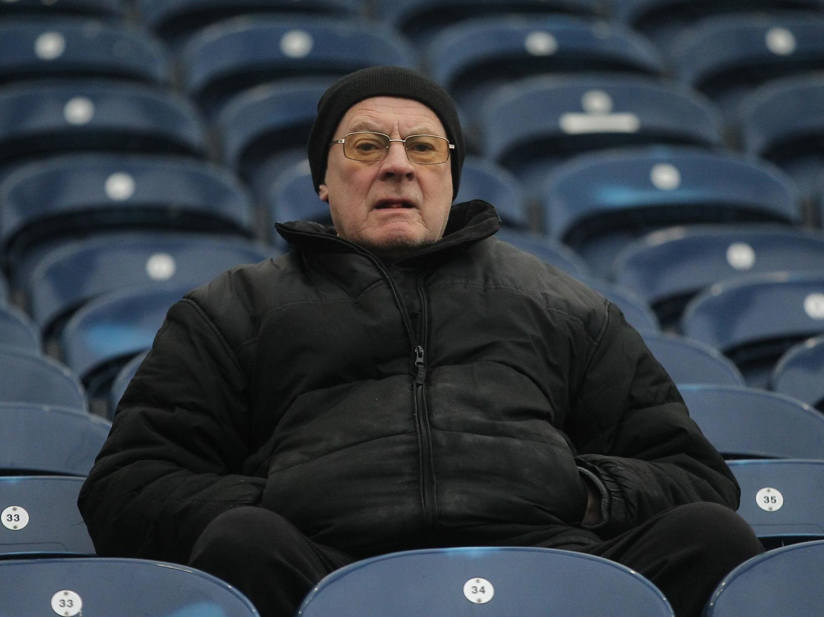 A North End fan doesn't look best pleased as our photographer turns his lens to him as early comers wait on.
