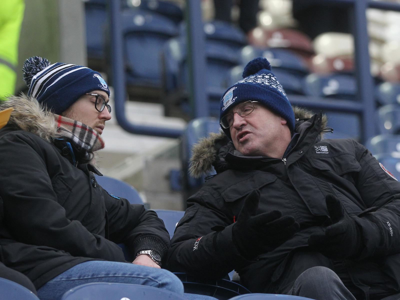 Two PNE fans have a chat as the Alan Kelly Town End fills up.