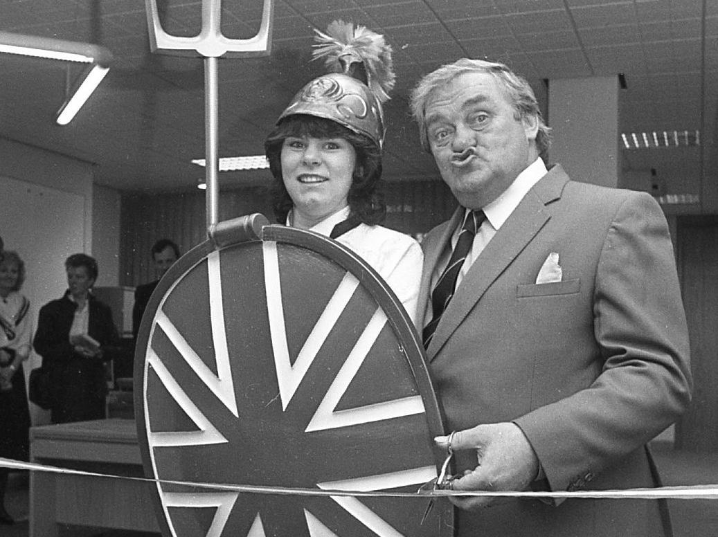 Birthday boy Les Dawson smacked a real "Cosmo kiss" at Britannia as he cut the tape at a seaside savings office. The Lancashire comedian celebrated his 55th birthday as he opened Blackpool's first Britannia building society in Clifton Road. Lucky Britannia - caterer Janet Wilson - stepped into her glad rags while she served food at the celebration opening