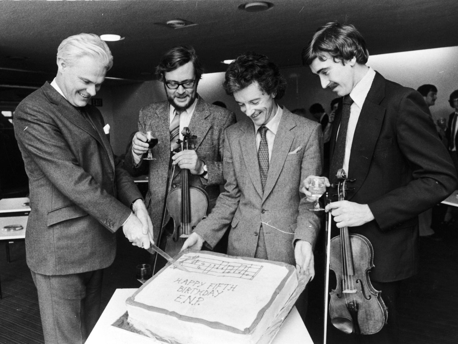 Opera North's orchestra, the English Northern Philharmonia, celebrated its fifth birthday in Leeds. Principal conductor and artistic director David Lloyd-Jones, cuts the cake at Pudsey Civic Hall.