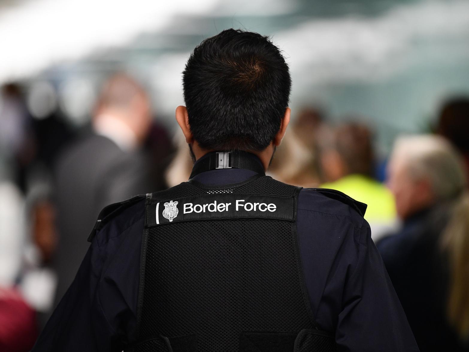 A member UK Border Force patrols at Heathrow Airport in London (Photo by DANIEL LEAL-OLIVAS/AFP via Getty Images)