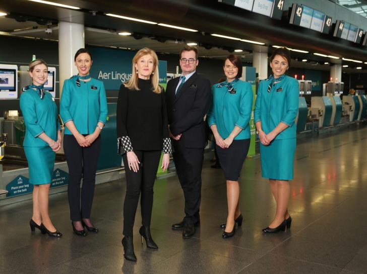 Aer Lingus cabin crew this month sported for first time new uniform, designed by "queen of irish fashion" Louise Kennedy, now worn by over 4,000 airline staff.