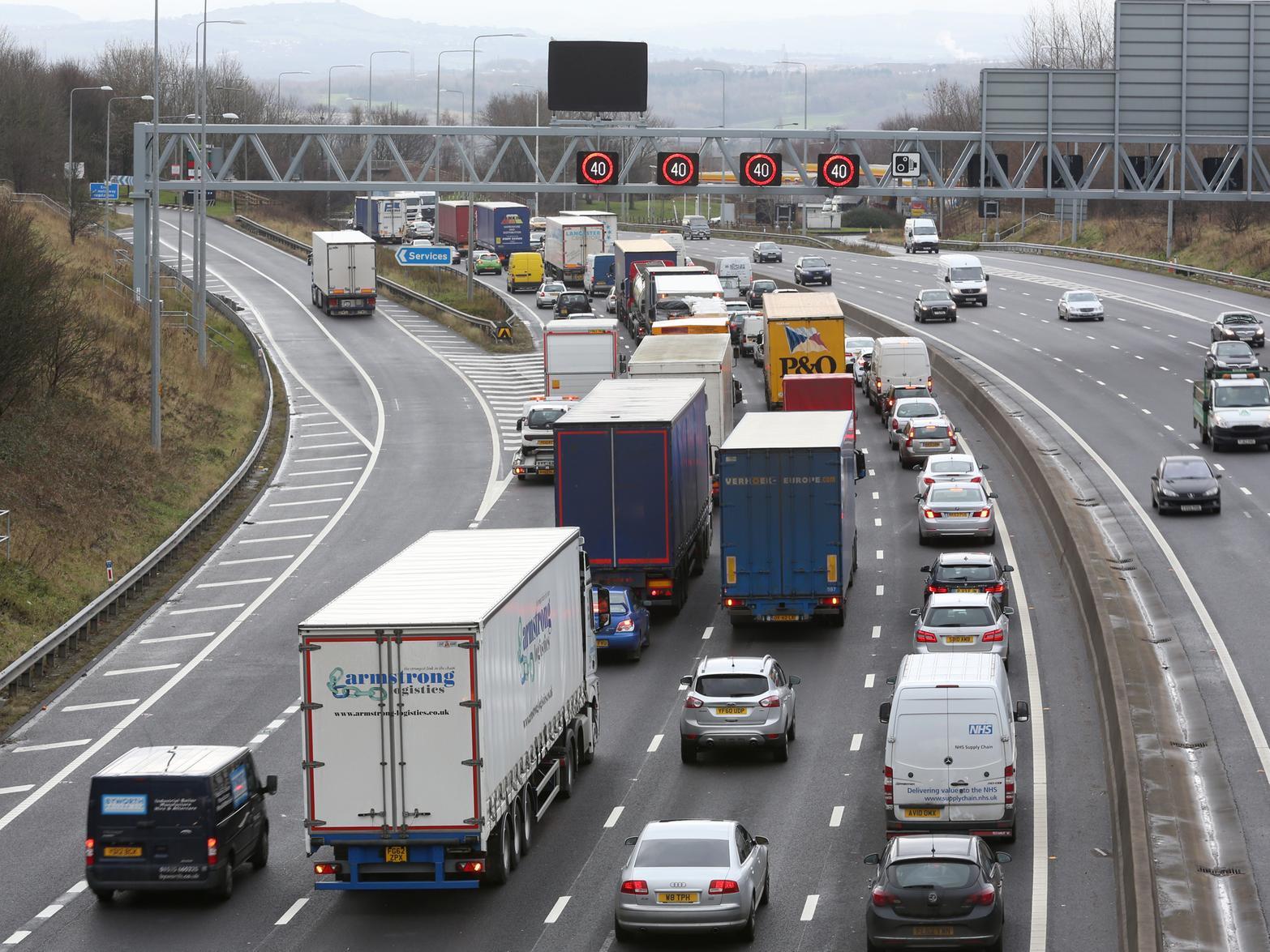 A police officer was hit by a car while helping a broken down van driver on the M62.