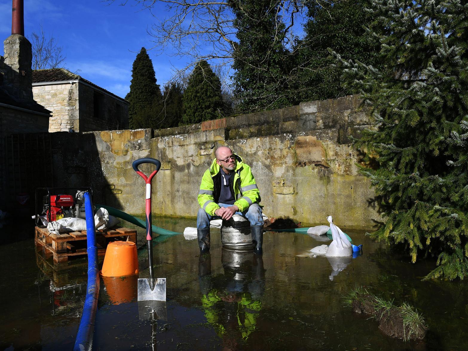 Kirkby Wharfe resident Pete Mitchell in his flooded garden.