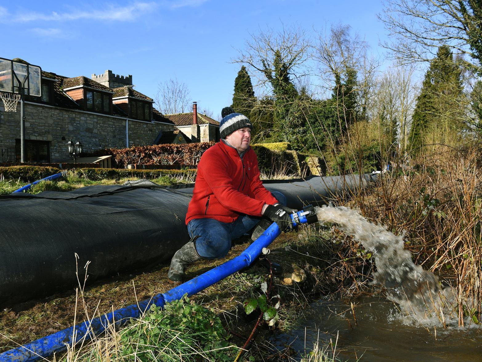 Kirkby Wharfe resident Richard Oldfield pumps water out of the property's gardens.