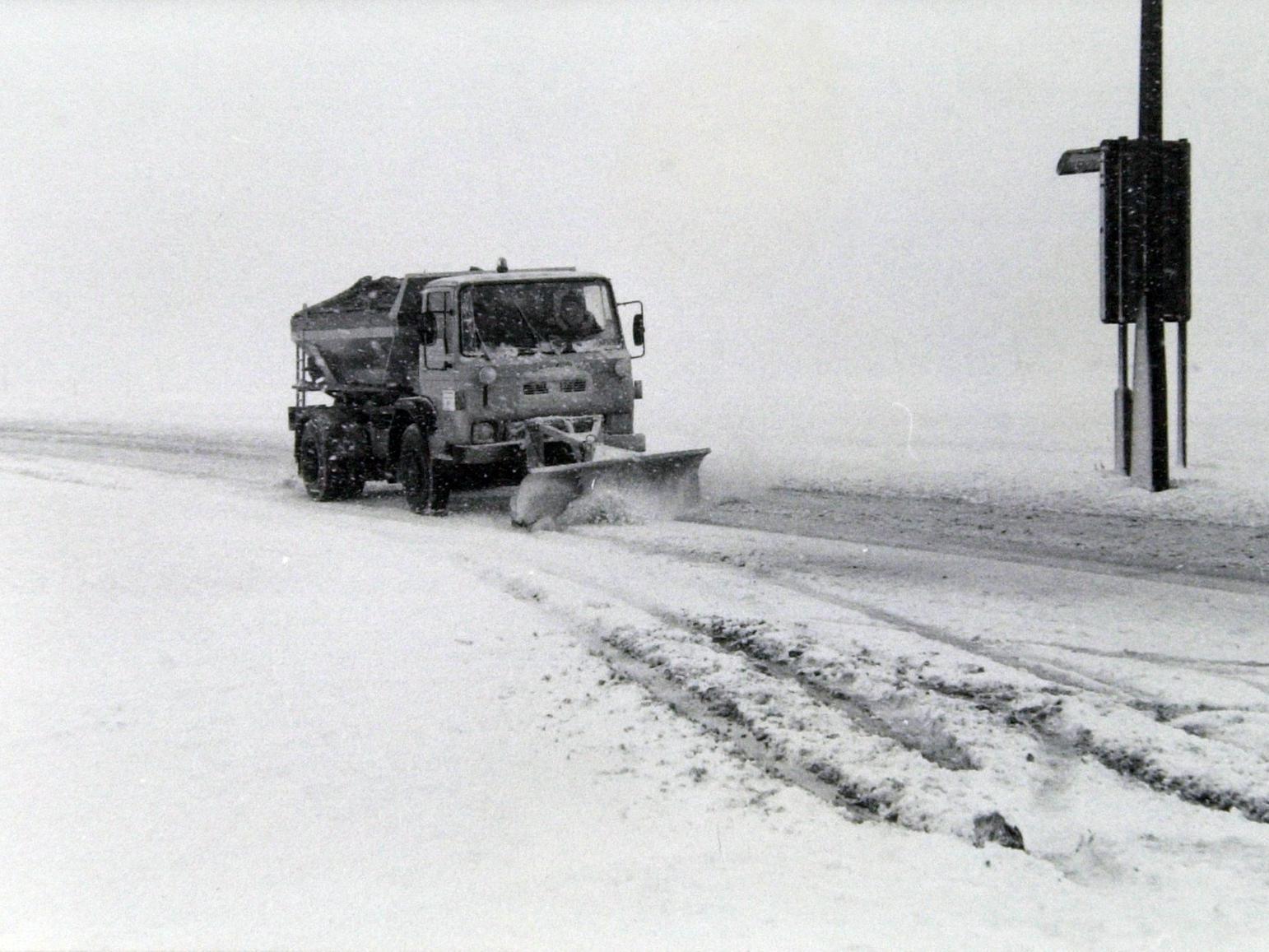 A snow plough makes its way up Scot Hall Road.