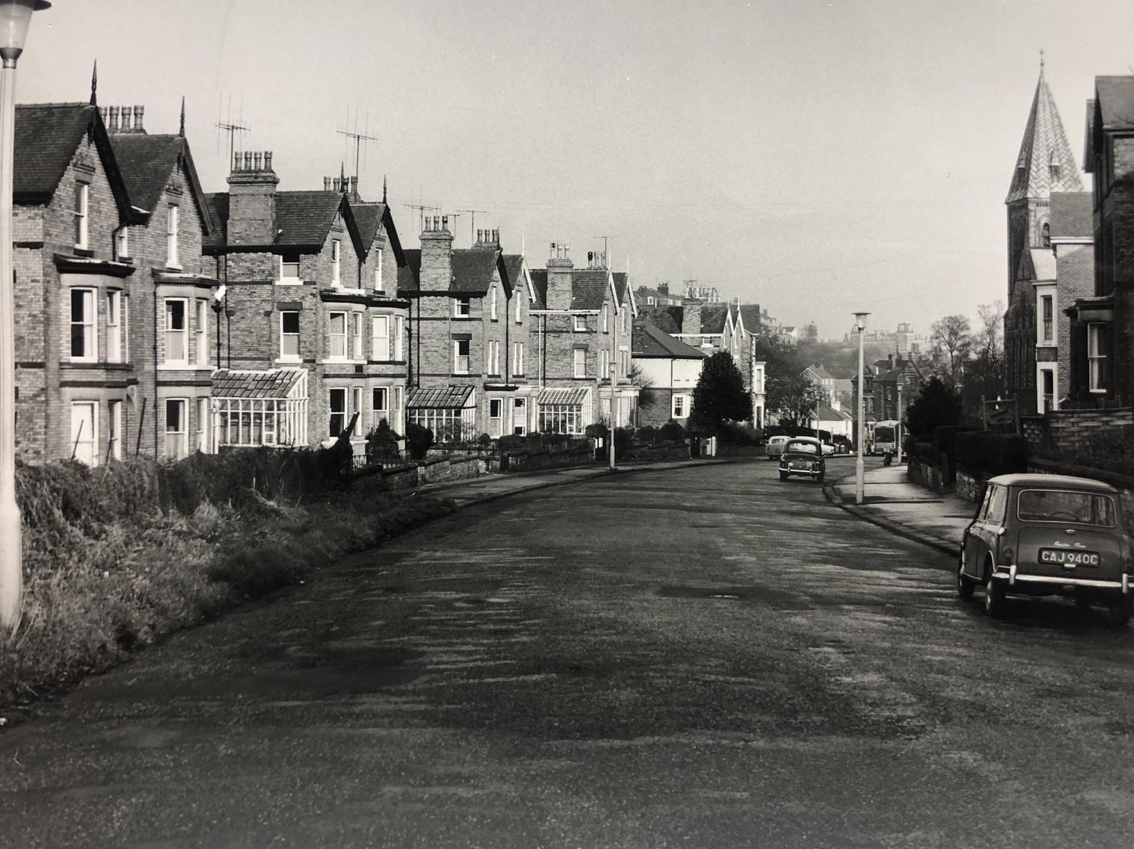 Taken in February 1967, the road hasnt changed much since this photo was taken. The buildings are all still there, the church has since been converted into flats. However the cars and street lamps show the passing years.