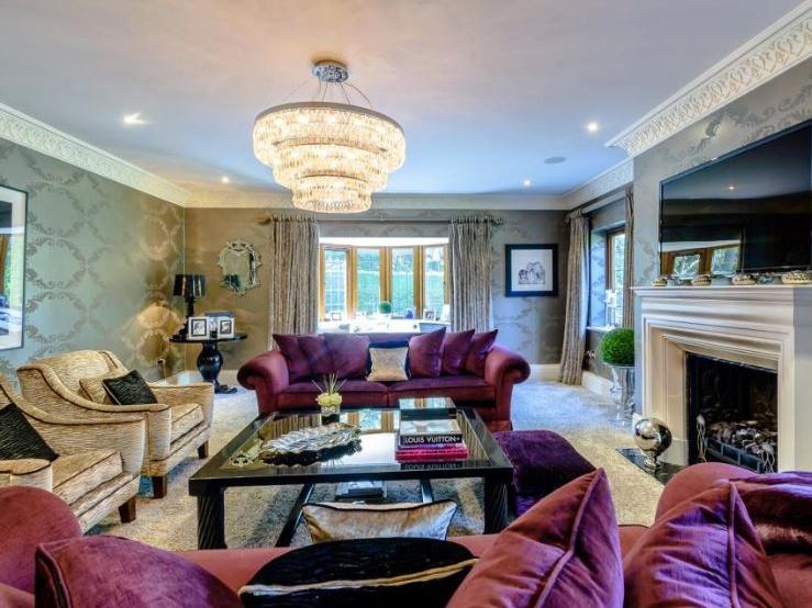 A double aspect drawing room and sitting room (complete with cinema) offer two further reception rooms.