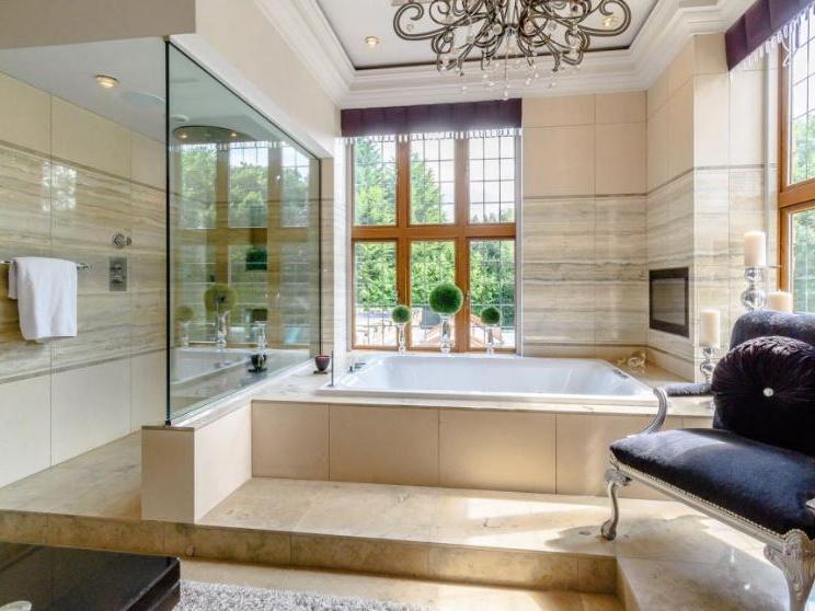 The magnificent en-suite bathroom which boasts a balcony overlooking the gardens.