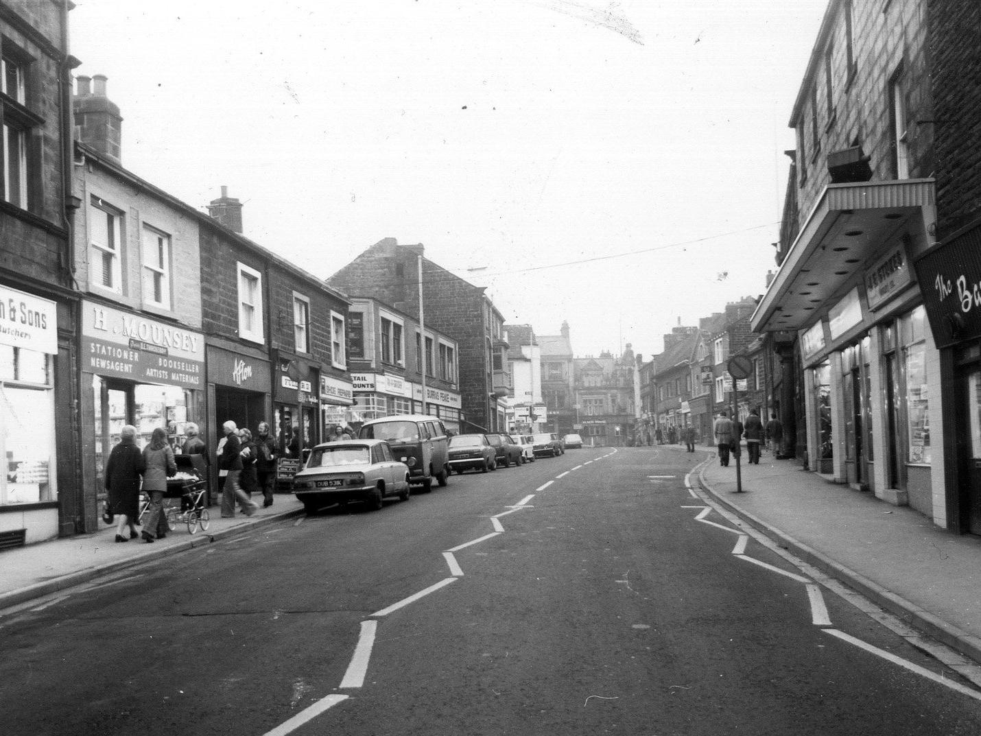 Boroughgate. Shops visible, on the left, include J.B. Wilkinson & Sons, butchers, H. Mounsey, stationer and Afton ladieswear. On the right are John Wood's Barber Shop, J.E. Stokes Ltd., fancy goods, and R.A. Stores, camping.