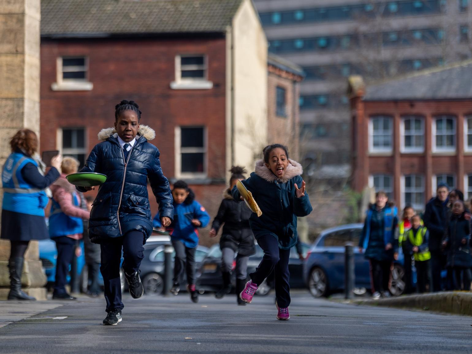 School children take part in a Pancake Day race outside Leeds Minster on Shrove Tuesday