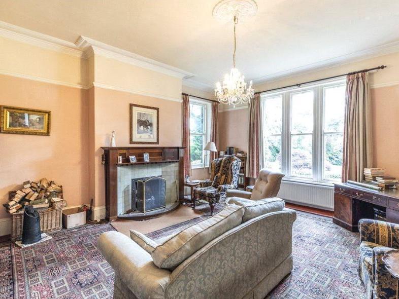 The cosy sitting room also has a traditional charm, with period features and and ornate fireplace, boasting views over the gardens.