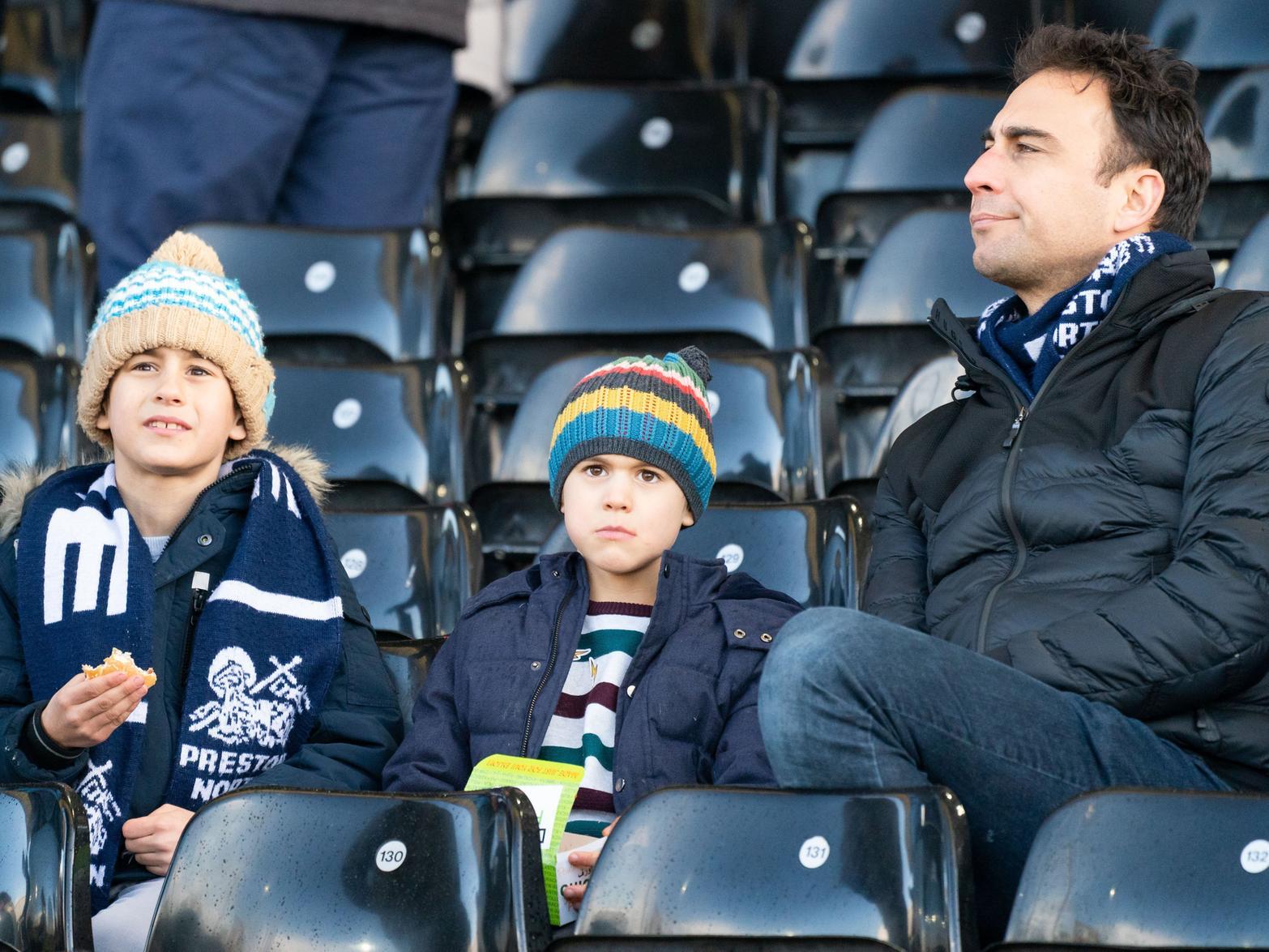 Three PNE fans are settled in the away end at Craven Cottage.