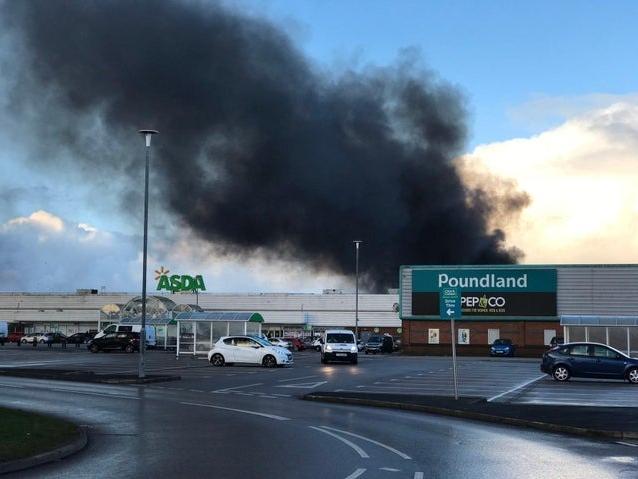 Thick, black plumes of smoke can be seen towering above the nearby Asda superstore. Pic: Stephen Cheatley