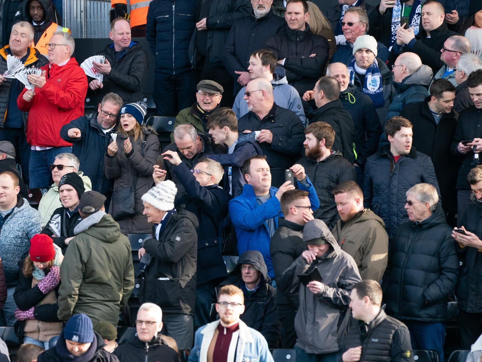 Fulham fans on the left hold their clappers while PNE fans needed no such help, as the away section begins.
