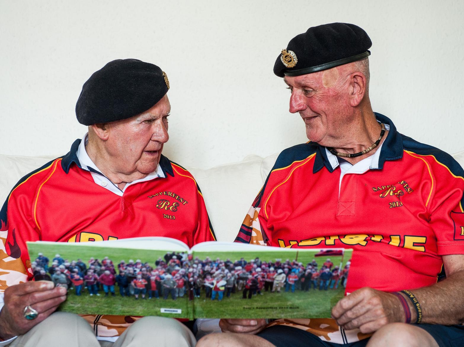 Sapper Bill Nicholson presents Tom Gilzean with a photobook of pictures from the 2013 Sapperfest which Tom attended as the oldest sapper at the age of 93