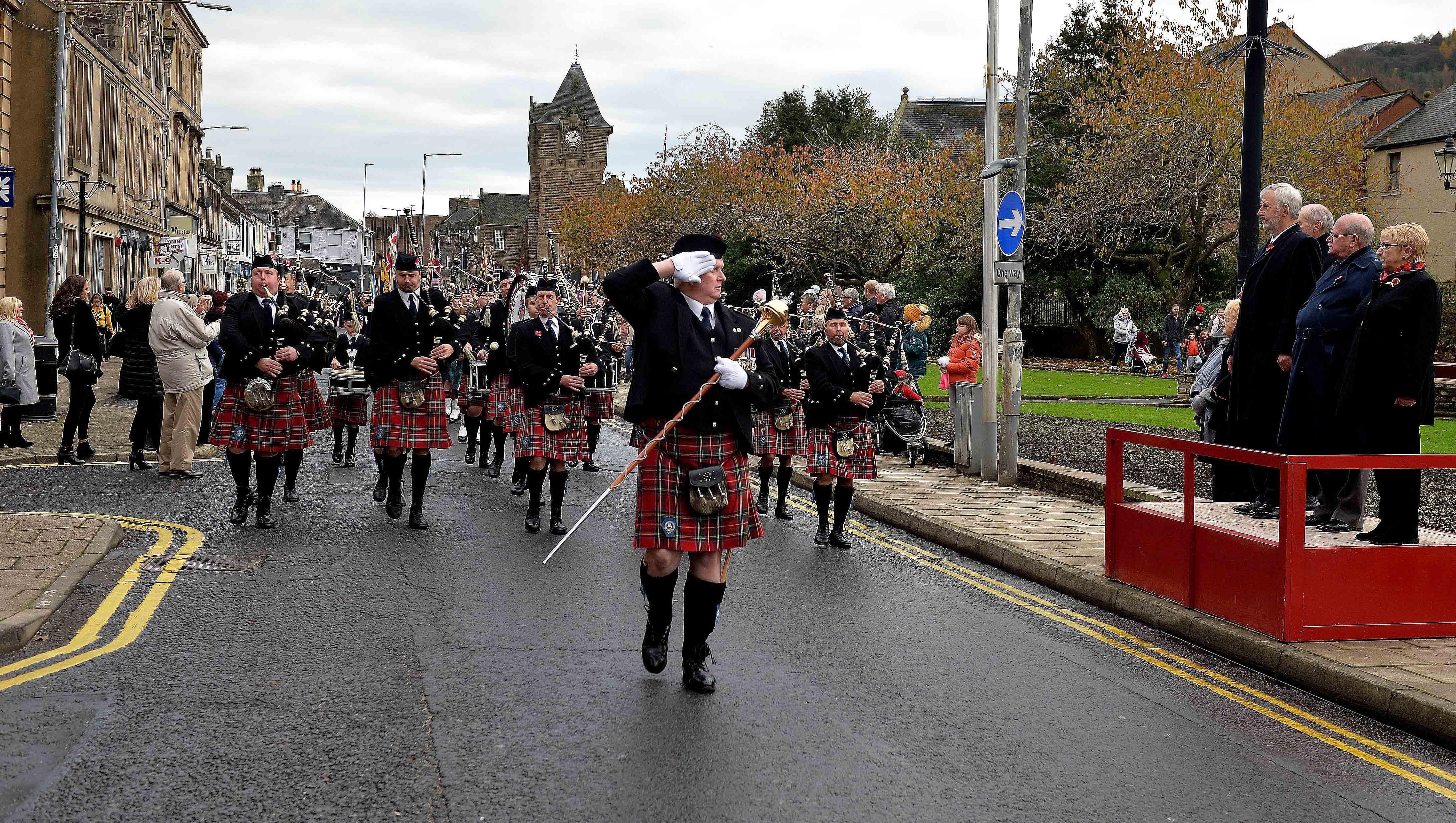 Deputy Lord Lieutenant Mike Gray takes the salute from drum major Iain Brown in Galashiels.