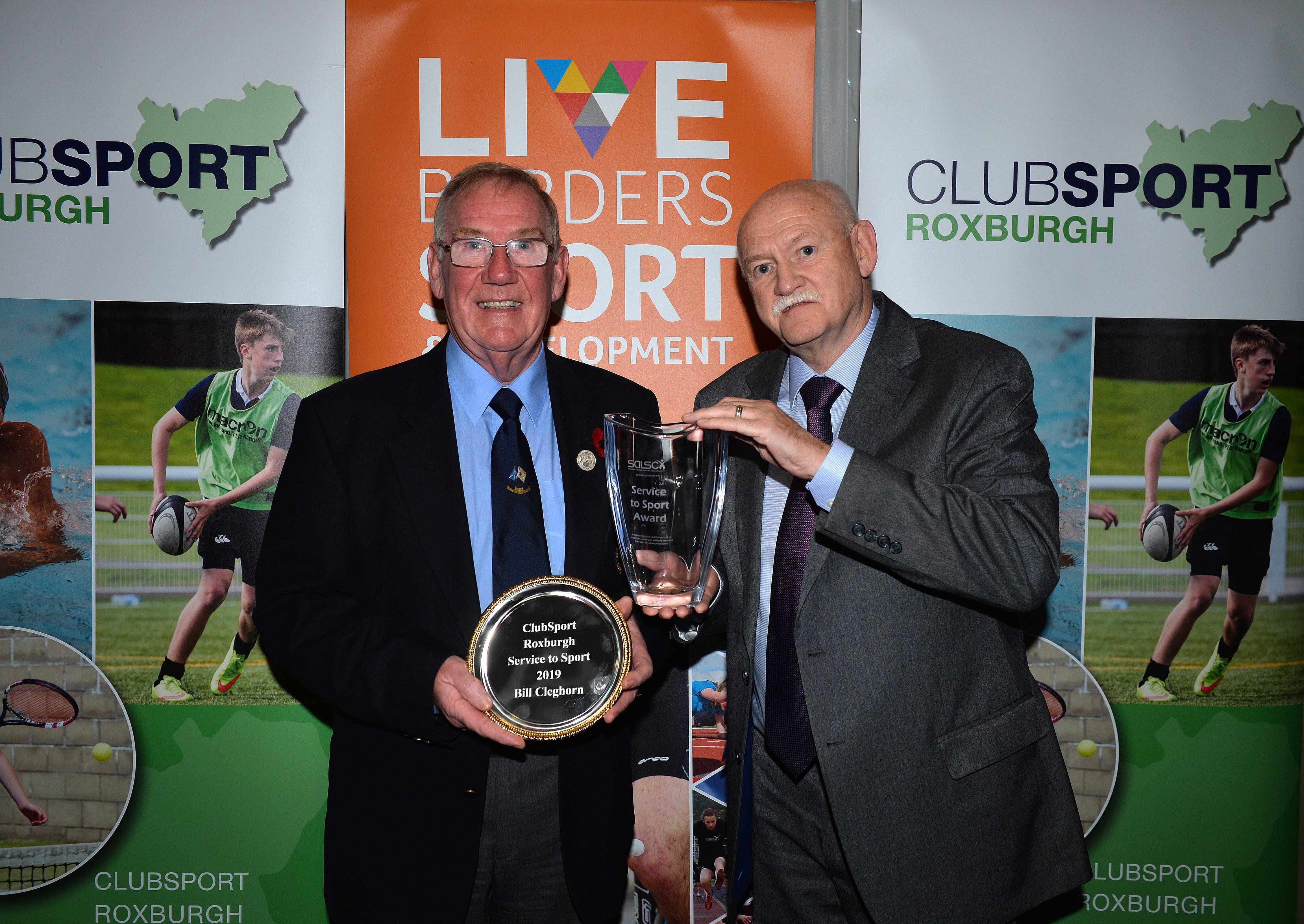 Curling stalwart Bill Cleghorn, left, collects a Services to Sport accolade from Rick Kenny.