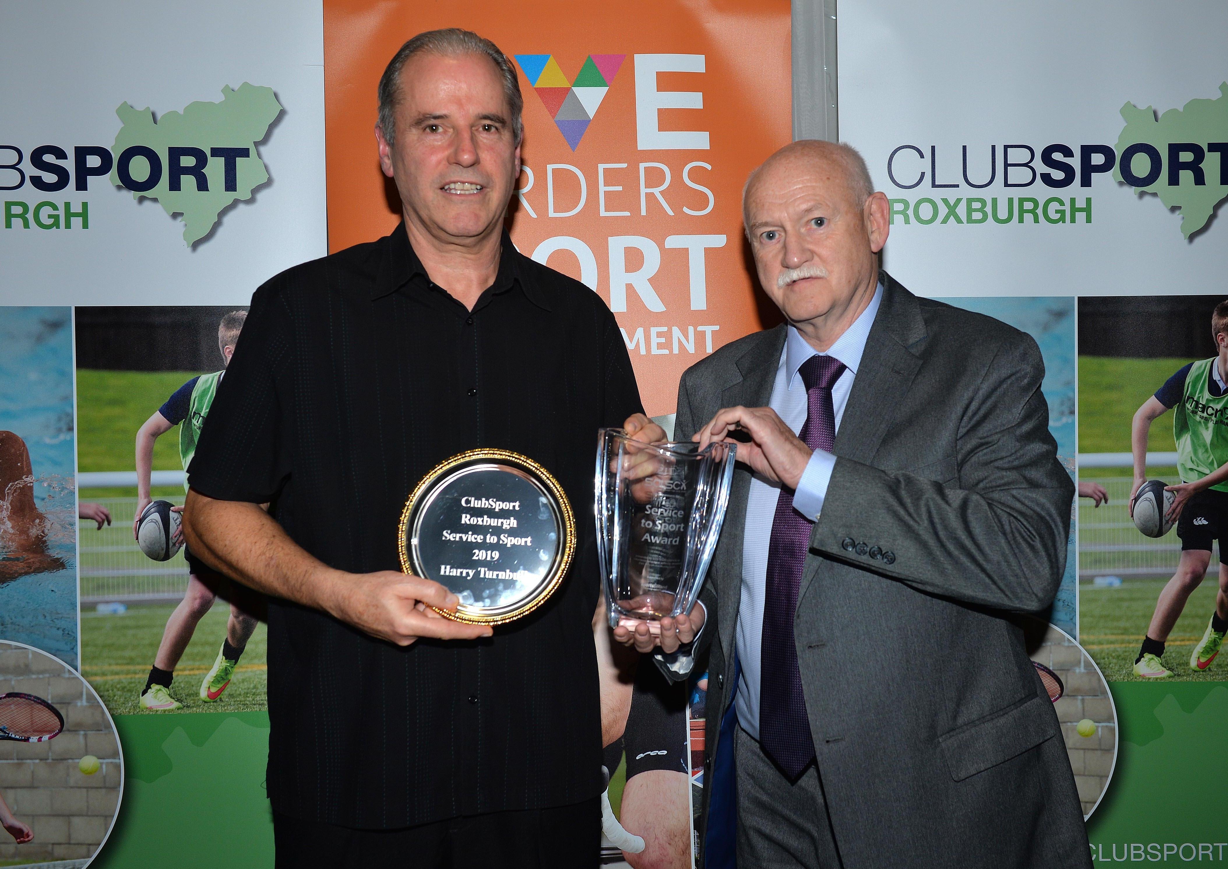 RIck Kenny, right, handed over a Services to Sport Award to Harry Turnbull for his work promoting badminton.