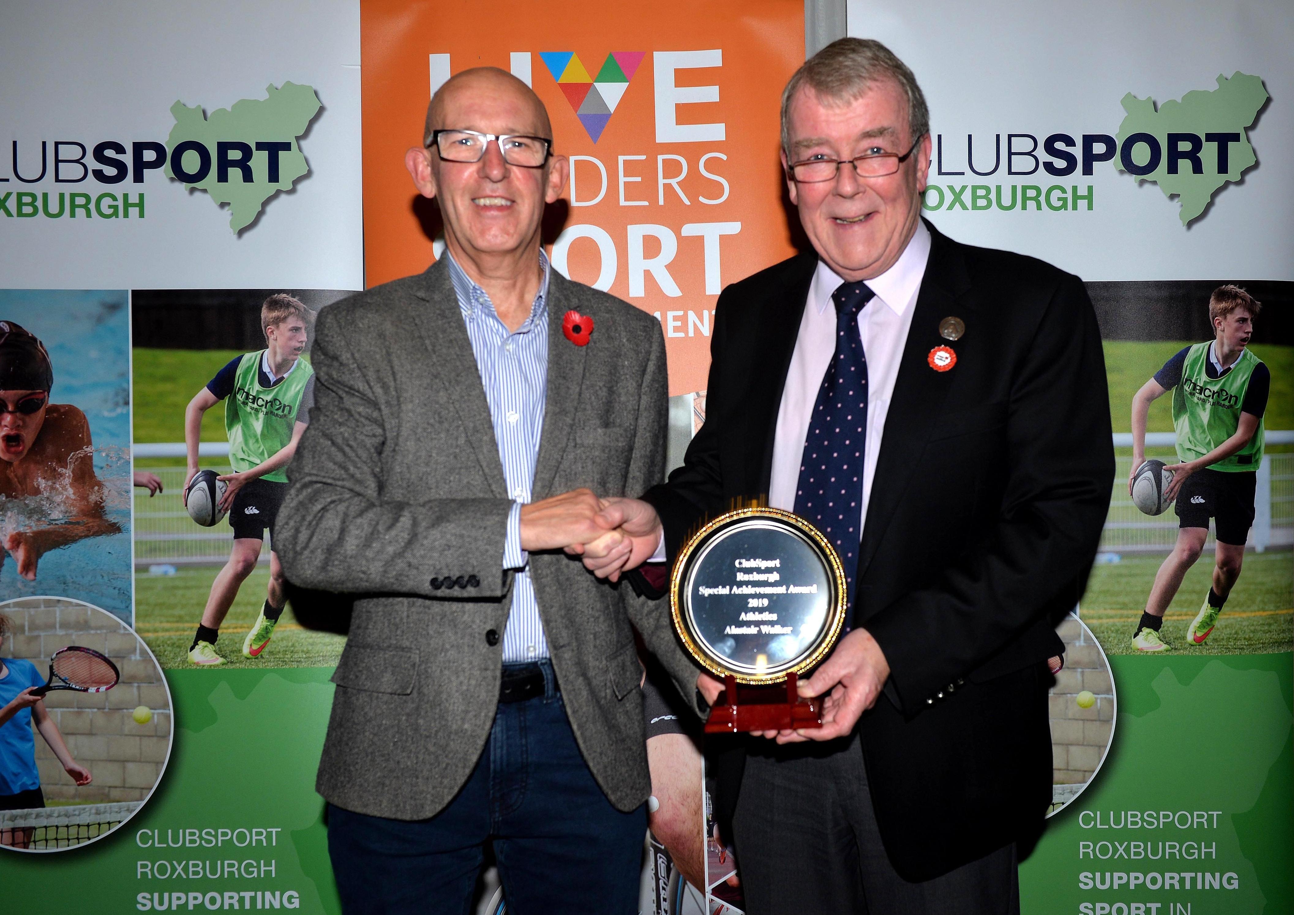 Hawick athlete Alastair Walker, left, collects a Special Achievement Award from Councillor George Turnbull.