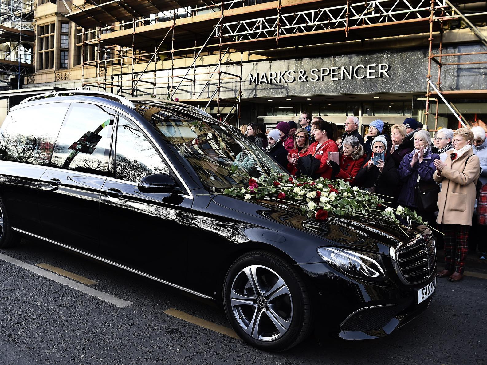 Hundreds of mourners lined Princes Street and applauded as the funeral cortege of Edinburgh fundraising hero Tom Gilzean passed along the city thoroughfare. Pictures by Lisa Ferguson.