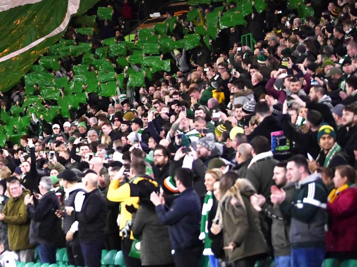 Celtic supporters applaud their team at the start of the match