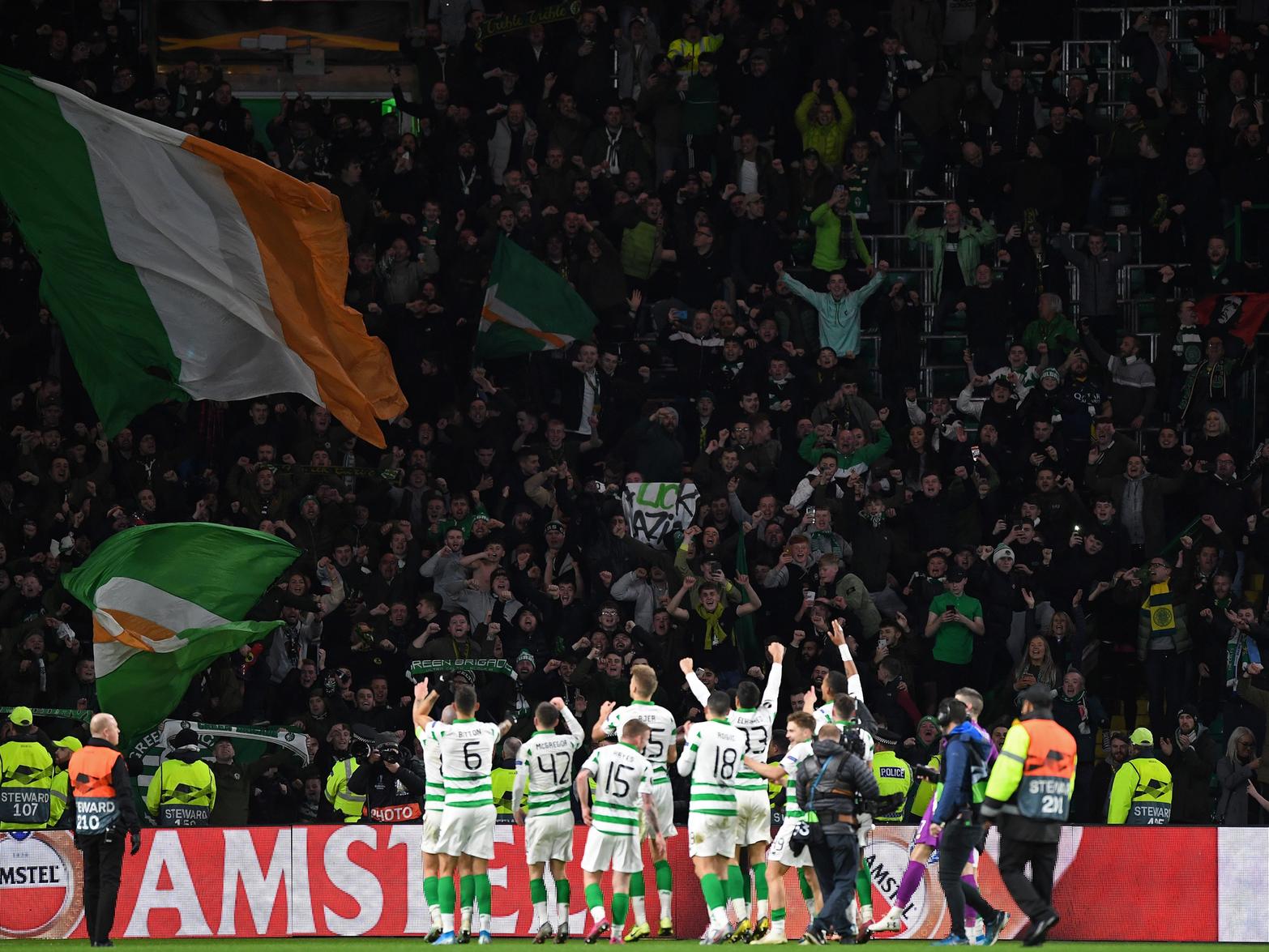 Celtic fans salute their team at full time after a famous win in Europe
