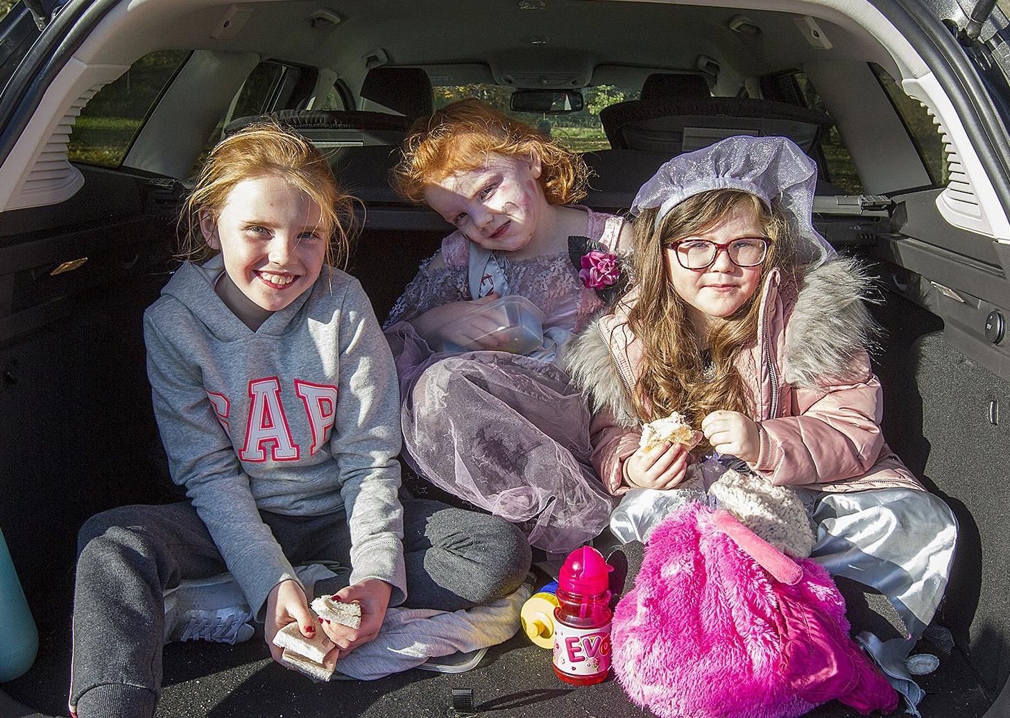 Emily Thorburn and Grace and Evangelina Gilhooley from Peebles enjoying a snack in the boot of the car