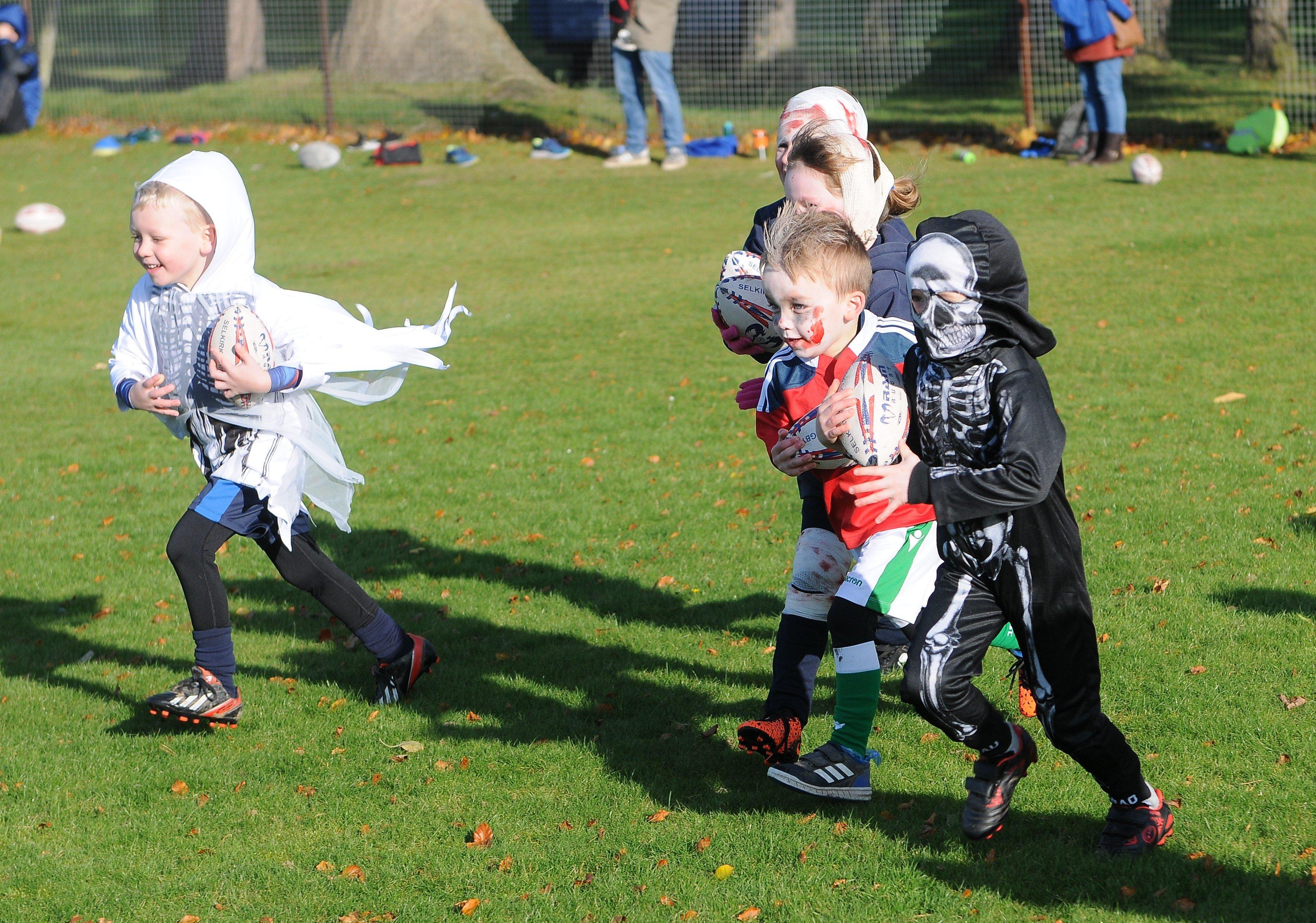 Youngsters playing rugby at a Halloween-themed Selkirk Rhinos training session.