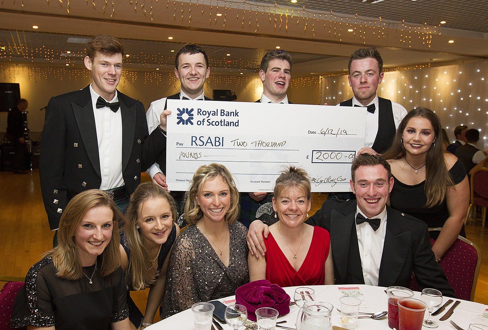 A cheque handover at Friday's young farmers' ball in Kelso.