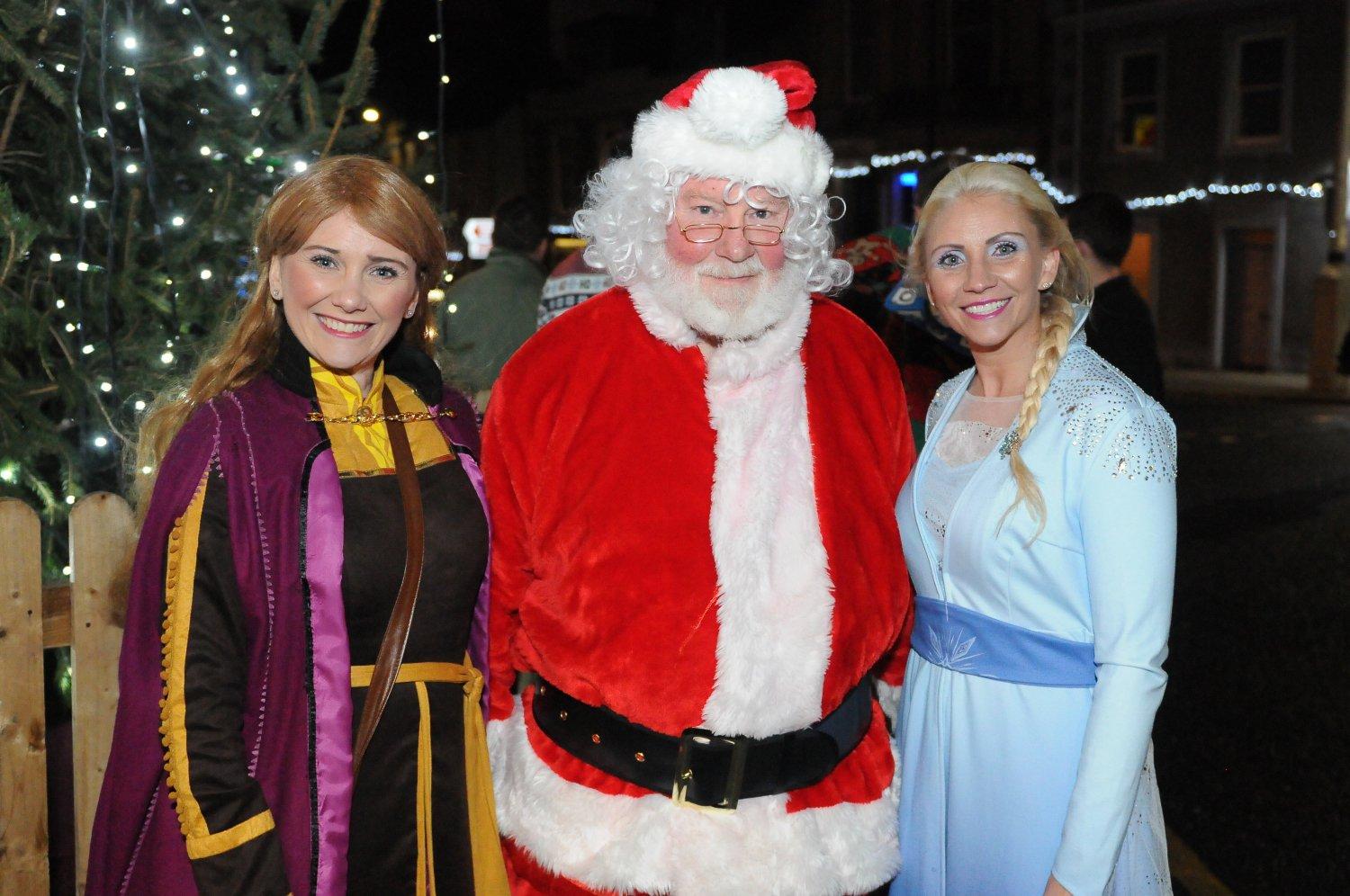 Ana and Elsa from Frozen with Santa.
