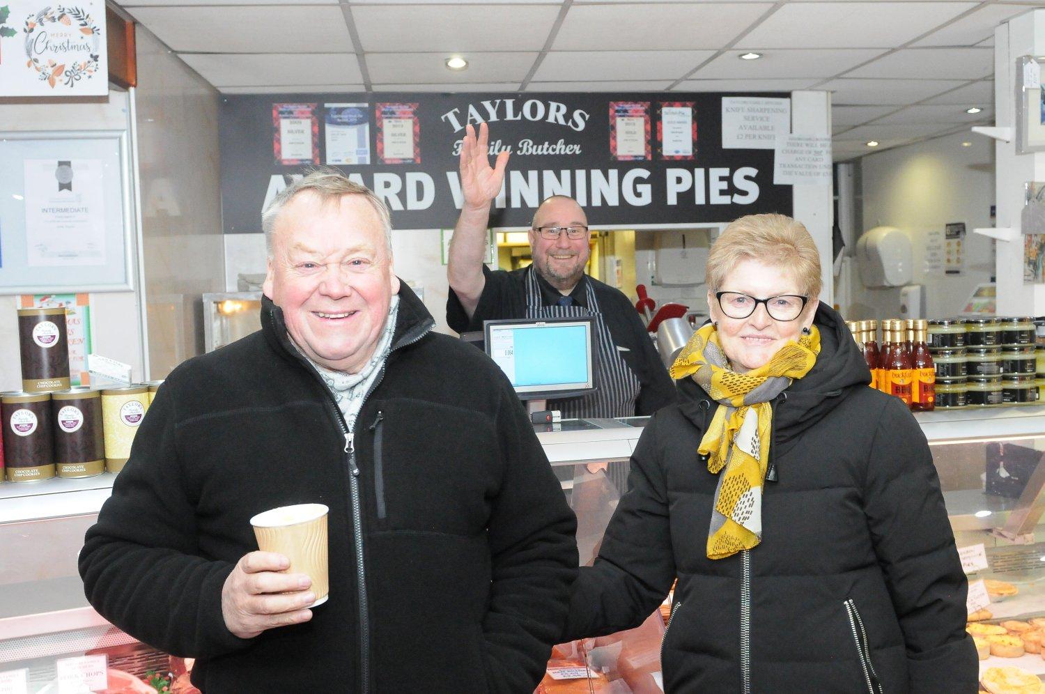 Local shops stayed open for the switch-on ... here, John Taylor the butcher is pictured with Peter and Edith Scott.